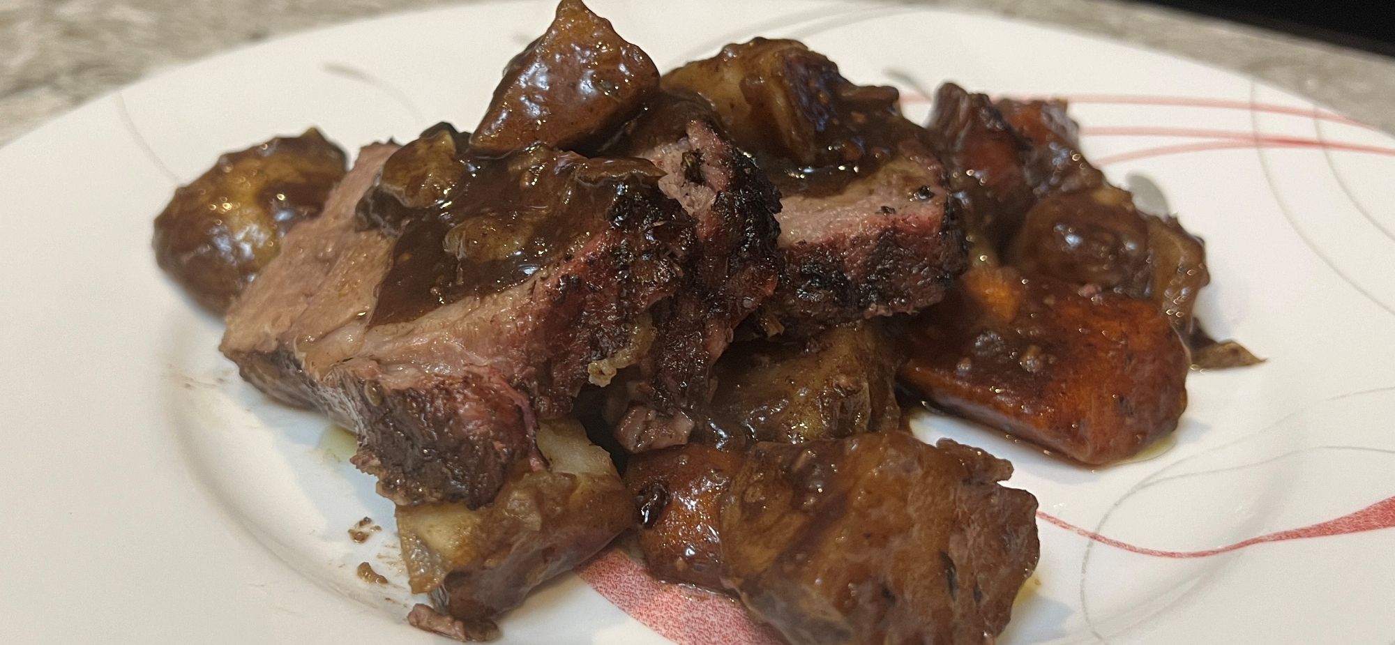 Beef Short Ribs with gravy on a plate